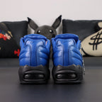 Supreme x Air Max 95 Lux Hyper Cobalt - Tongue and Insole Top Down View on Dark Background Showing Debossed Supreme New York Script on Blue Leather Tongue and Gold Supreme x NK SB Made in Italy Co-Branding on Black Insole