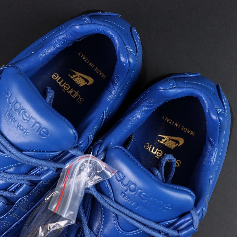 Supreme x Air Max 95 Lux Hyper Cobalt - Toe Box Close Up on Dark Background Showing Premium Hyper Cobalt Blue Smooth Leather Toe Box Tone-on-Tone Supreme Cursive Script Debossed on Blue Leather Quarter Panel and Gold Accent Detail
