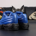 Supreme x Air Max 95 Lux Hyper Cobalt - Lateral Profile View on Dark Background with Pikachu Plush Showing Hyper Cobalt Blue Leather AM95 Spine Overlays Tone-on-Tone Supreme Script and Full Black Midsole