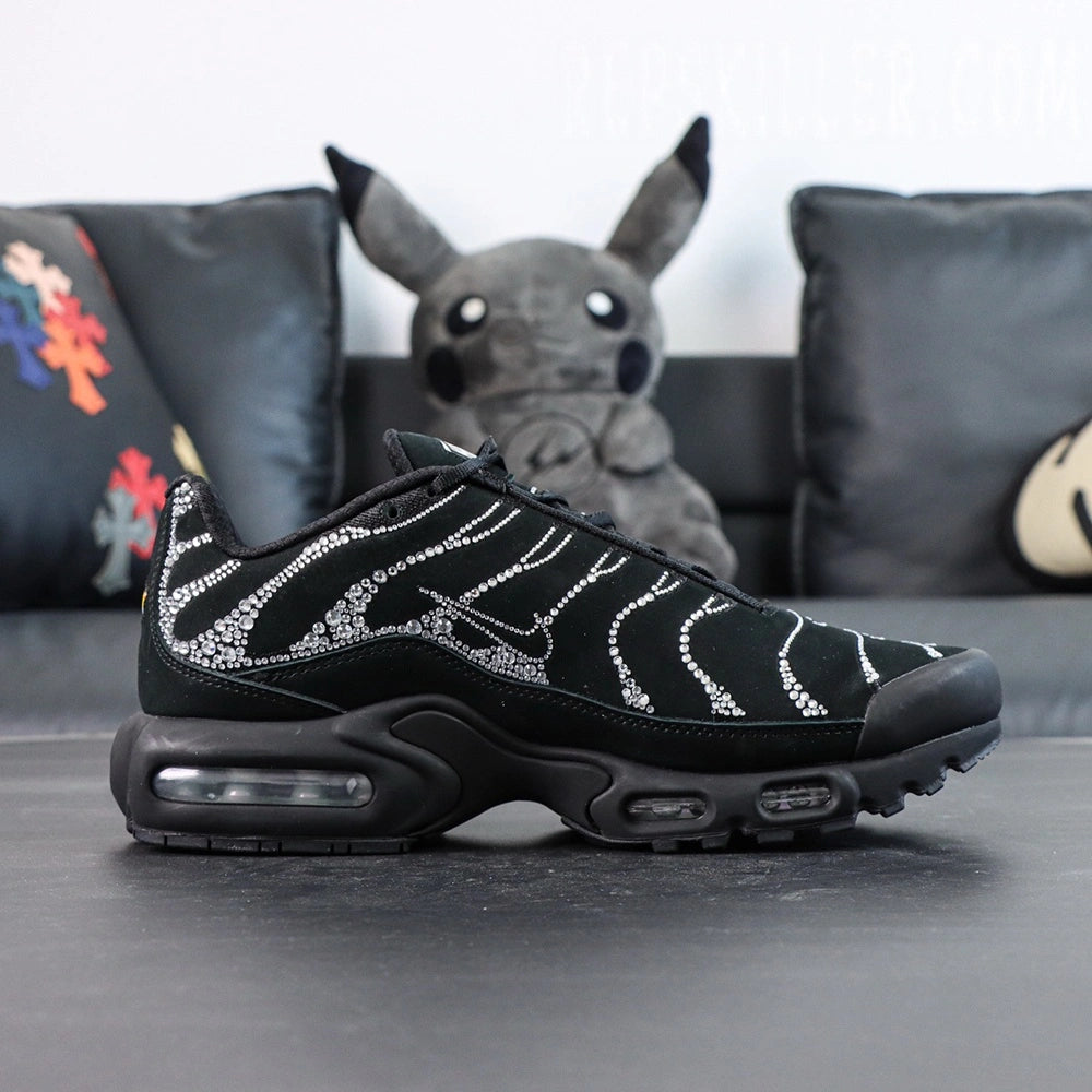 Swarovski x Air Max Plus Moonlight 2024 - Rear Heel View of Both Shoes with Pikachu Plush on Dark Background Showing Swarovski Crystal Rhinestone Coverage on Heel Counter Wave-Form Lines and Yellow Tn AIR Badge on Heel Tab