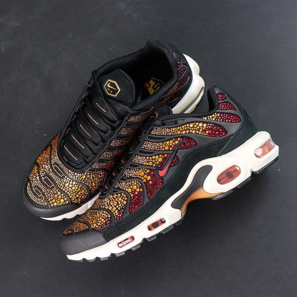 Swarovski x Air Max Plus Sunset - Rear Heel View of Both Shoes on Dark Background Showing Deep Crimson Swarovski Crystal Heel Counter Panels Yellow Tn AIR Badge on Heel Tab and White Midsole with Amber-Tinted TN Air Cushioning Unit