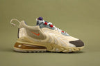 Air Max 270 React Cactus Jack Light Cream Starfish CT2864-200 - Toe Box Close Up on Olive Background Showing Deep Espresso Dark Brown Leather Toe Cap with White Mini Swoosh Embroidery Cream Terry-Loop Pile Suede Upper Slate Blue Leather Lace Collar Overlay and Cream React Midsole