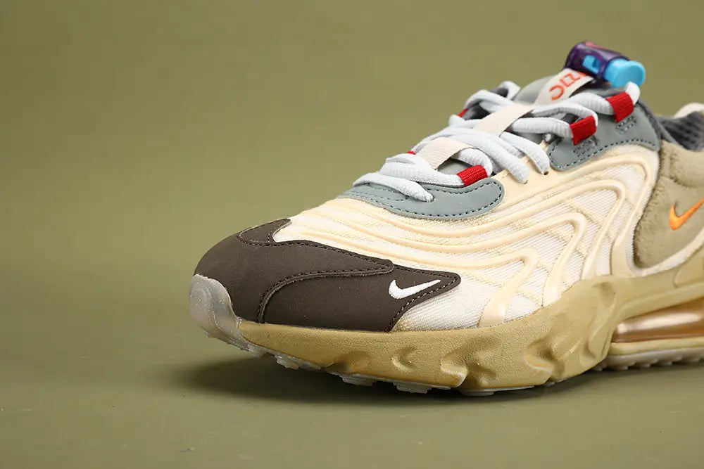 Air Max 270 React Cactus Jack Light Cream Starfish CT2864-200 - Rear Heel View of Both Shoes on Olive Background Showing Cream Woven Ribbon Heel Pull Tabs with Red CACTUS JACK Hand-Script Text Embroidery and Red Cactus Logo Deep Espresso Leather Heel Counter Patch and Large-Volume Gum Amber 270 Air Unit in Cream React Midsole