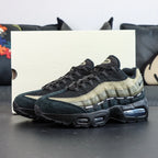 Undefeated x Air Max 95 Medium Olive 2025 — lifestyle shot with box