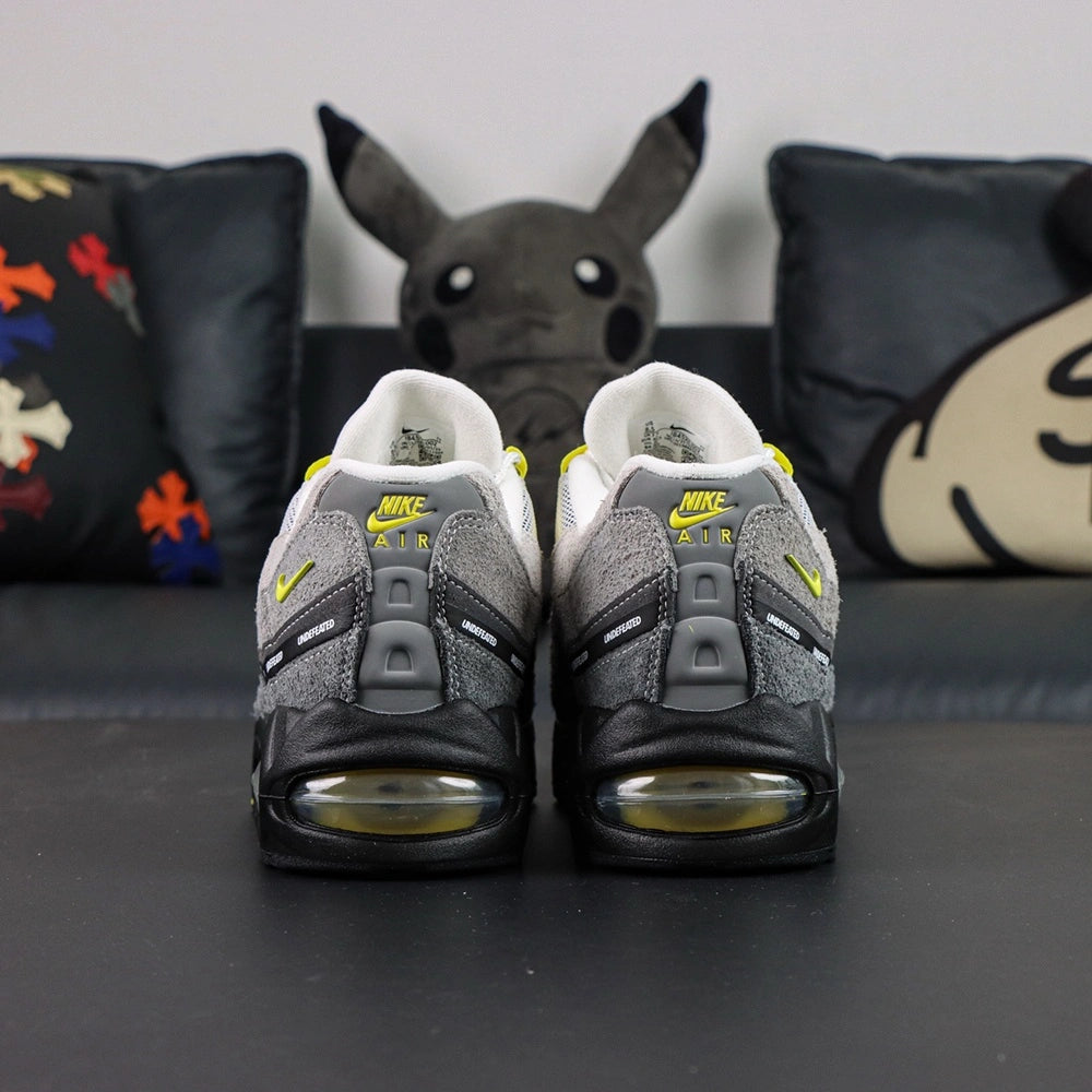 Undefeated x Air Max 95 Yellow 2025 — lateral pair view with box
