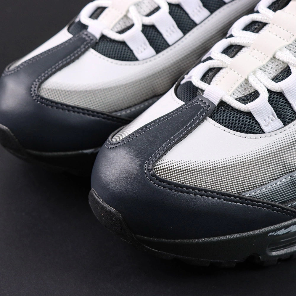 Yu-Gi-Oh x Air Max Muscle 95 QS Jonouchi 2025 — heel pair view showing NK AIR branding and grey Air units