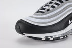 Air Max 97 Black Metallic Silver - Tongue and Lace Area Top Down View on White Background Showing White Tongue Black Air Max Text Woven Ribbon Pull Tab Black Flat Laces and White Ripstop Mesh Quarter Panel with Metallic Silver Stripe Bands
