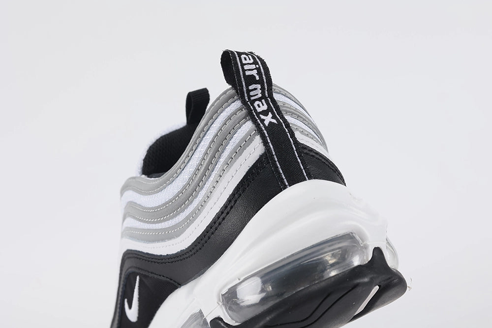 Air Max 97 Black Metallic Silver - Rear Heel View of Both Shoes on White Background Showing Black Air Max Text Woven Ribbon Heel Pull Tab on Both Sides Black Leather Ankle Collar and Large-Volume Transparent Full-Length AM97 Air Unit in White Midsole