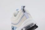 Air Max 97 Ghost - Three-Quarter Lateral View of Both Shoes on White Background Showing Sail Perforated Leather AM97 Upper Ghost Blue Matte Wave Stripe Bands Large Ghost Blue Suede Swoosh Panel and White Midsole with Transparent Heel Air Unit