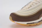 Air Max 97 Muslin Pink Foam - Rear Heel View of Both Shoes on White Background Showing Dark Brown Air Max Text Woven Ribbon Heel Pull Tabs on Both Sides White Swoosh on Dark Brown Leather Heel Counter and Full-Length Transparent AM97 Air Unit in White Midsole with Gum Outsole