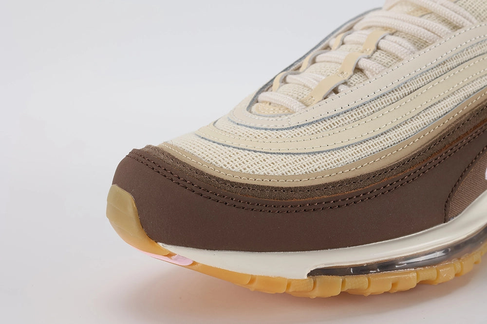 Air Max 97 Muslin Pink Foam - Rear Heel View of Both Shoes on White Background Showing Dark Brown Air Max Text Woven Ribbon Heel Pull Tabs on Both Sides White Swoosh on Dark Brown Leather Heel Counter and Full-Length Transparent AM97 Air Unit in White Midsole with Gum Outsole