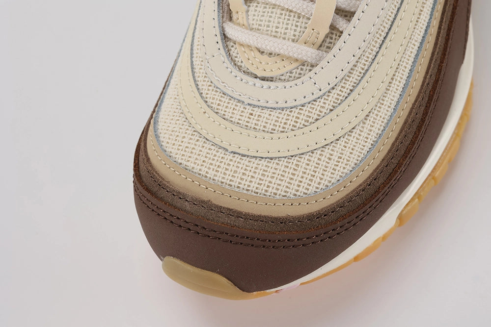 Air Max 97 Muslin Pink Foam - Full Outsole View on White Background Showing Full Gum Amber Rubber Outsole X-Block and Square Traction Pattern and Dark Brown Circular Heel Medallion with White Swoosh Logo