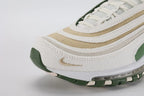 Air Max 97 SE Sun Club Sail Treeline - Toe Box Close Up on White Background Showing Sail Fine Perforated Mesh Toe Box Tan Khaki Coarse Burlap-Weave Mesh Mid-Stripe Silver Metallic Fine Woven Textile Lower Stripe and Tan Swoosh Embroidery on Lateral Toe Box