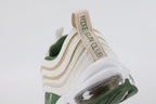 Air Max 97 SE Sun Club Sail Treeline - Heel Pull Tab Close Up on White Background Showing Sail Woven Ribbon Pull Tab with Green SUN CLUB Text Embroidery Running Vertically Treeline Green Knit Ankle Collar and Transparent AM97 Air Unit with Treeline Green Outsole Wrap