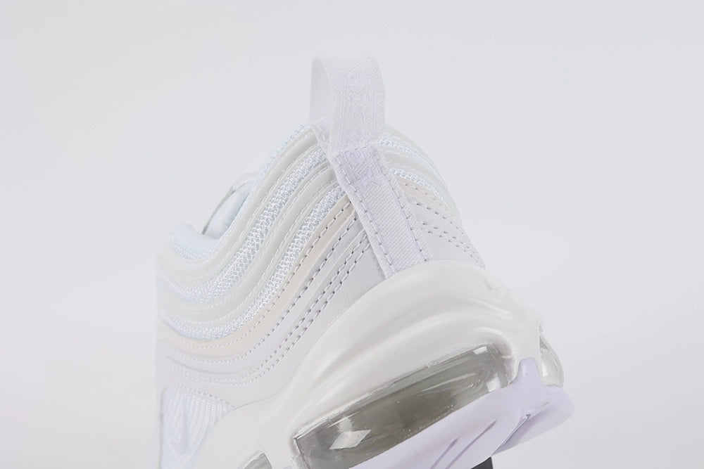 Air Max 97 Triple White - Tongue and Ankle Collar Close Up on White Background Showing White Tongue Circular White Perforated Leather Badge with White Swoosh Embroidery Ice Blue Textile Ankle Collar Lining and White Flat Laces