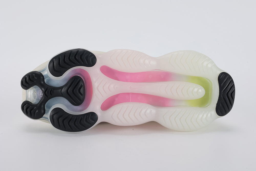 Air Max Scorpion Air Max Day - Heel Counter Close Up on White Background Showing White Woven Ribbon Heel Pull Tab with Black Dot-Texture Rubber Patch at Top Multicolour Rainbow Flyknit Extending to Lateral Heel Panel and Volt Neon Yellow Air Chamber Visible Through Frosted White Midsole Wall