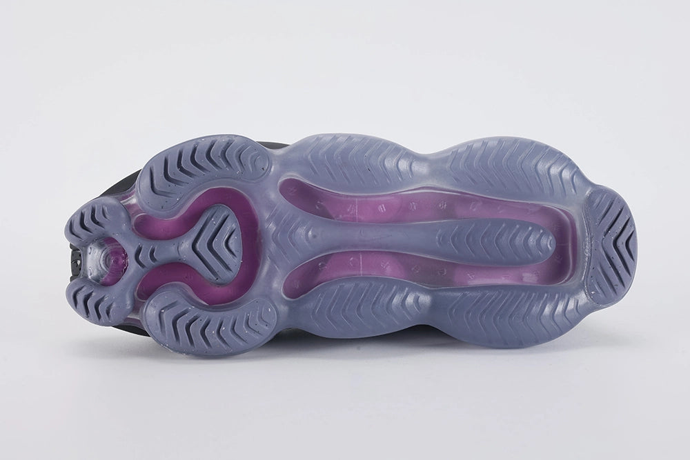 Air Max Scorpion Flyknit Black Persian Violet - Heel Counter Close Up on White Background Showing Black Wide Rubber Heel Pull Tab with Royal Blue Dot-Grid Texture Black Loop-Pile Flyknit High Ankle Collar and Persian Violet AM Scorpion Air Unit at Heel with Fuchsia Chambers Visible