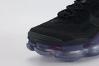 Air Max Scorpion Flyknit Black Persian Violet - Tongue and Lace Area Top Down View on White Background Showing Rectangular Royal Blue Dot-Grid Tongue Badge Black Tonal Mini Swoosh Embroidery Black Star-Form Lace Locks and Black Rope Laces on Black Loop-Pile Flyknit Upper