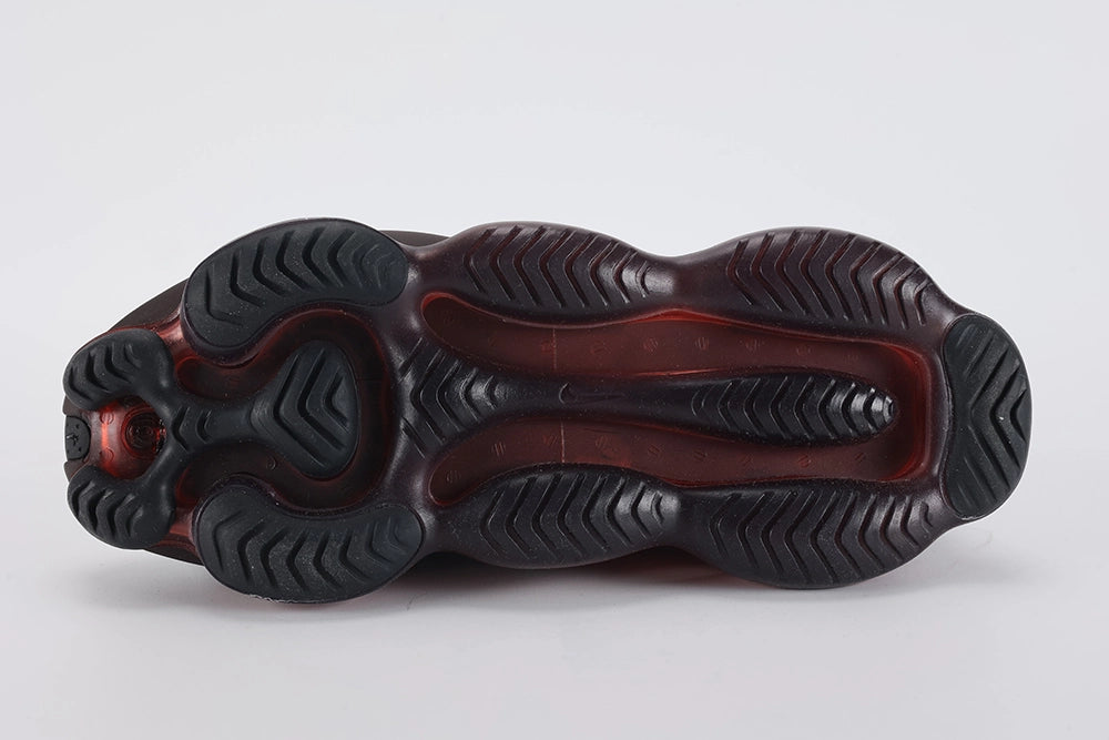 Air Max Scorpion Flyknit Bred Black University Red - Heel Counter Close Up on White Background Showing Black Wide Rubber Heel Pull Tab with Crimson Dot-Grid Texture Black High Ankle Collar White Mini Swoosh on Lateral Heel Midsole Counter and Deep Burgundy AM Scorpion Air Unit at Heel