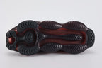 Air Max Scorpion Flyknit Bred Black University Red - Heel Counter Close Up on White Background Showing Black Wide Rubber Heel Pull Tab with Crimson Dot-Grid Texture Black High Ankle Collar White Mini Swoosh on Lateral Heel Midsole Counter and Deep Burgundy AM Scorpion Air Unit at Heel