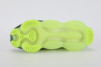 Air Max Scorpion Flyknit Cargo Khaki Volt - Heel Counter Close Up on White Background Showing White Horizontal Flyknit Stripe Bands Extending to Lateral Heel Panel Volt Oval Heel Pull Tab with White Dot-Grid Texture Cargo Khaki High Ankle Collar with Deep Forest Green Interior Lining and Volt to Forest Green Gradient AM Scorpion Air Unit at Heel