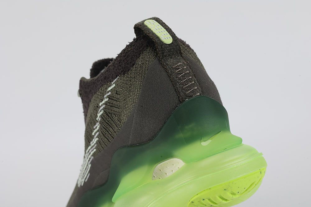 Air Max Scorpion Flyknit Cargo Khaki Volt - Rear View of Both Shoes on White Background Showing Volt Neon Yellow Oval Rubber Heel Pull Tabs with White Dot-Grid Texture on Both Sides Cargo Khaki High Ankle Collar with Deep Forest Green Interior Lining and Volt to Forest Green Gradient AM Scorpion Air Unit at Heel