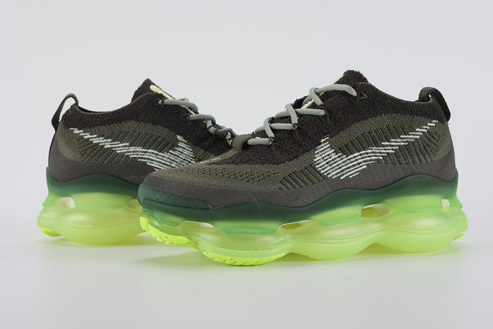 Air Max Scorpion Flyknit Cargo Khaki Volt - Full Outsole View on White Background Showing Full-Coverage Volt Neon Yellow Semi-Transparent AM Scorpion Air Base with Black Speckle Dots Volt Chevron Traction Pods at Forefoot and Heel Corners and Semi-Transparent Ice Green Central Air Chamber Base Zone