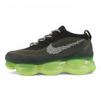 Air Max Scorpion Flyknit Cargo Khaki Volt - Full Lateral Profile View on White Background Showing Cargo Khaki Dual-Texture Flyknit AM Scorpion Upper White Horizontal Stripe Bands on Lateral Panel Volt Mini Swoosh on Toe Box Black X-Form Lace Locks Grey Flat Laces Volt Oval Lace Keeper and Volt to Forest Green Gradient AM Scorpion Air Unit