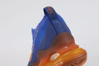 Air Max Scorpion Flyknit Frank Rudy Game Royal Total Orange - Lace Area and Lateral Heel Close Up on White Background Showing Orange Dot-Grid Tongue Badge Dark Navy Lace Locks White Rope Lace Multicolour Vertical Rainbow Stripe Embroidery on Lateral Heel Panel and Game Royal High Ankle Collar with Dark Navy Interior Lining