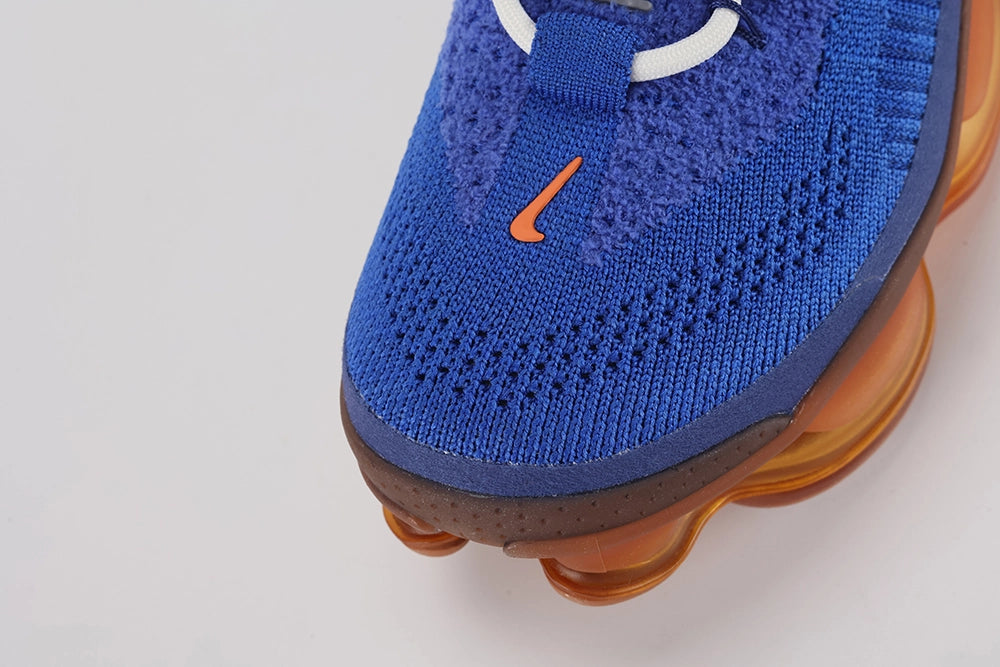 Air Max Scorpion Flyknit Frank Rudy Game Royal Total Orange - Rear View of Both Shoes on White Background Showing Game Royal Wide Rubber Heel Pull Tabs with Orange Dot-Grid Texture on Both Sides Game Royal High Ankle Collar with Dark Navy Interior Lining Multicolour Rainbow Stripe Embroidery and Total Orange to Amber AM Scorpion Air Unit at Heel