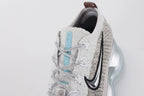Air Max Scorpion Flyknit Gaiter Light Bone Metallic Silver - Rear View of Both Shoes on Grey Background Showing Integrated Smoky Mauve Terry Cloth Gaiter at Heel Collar Powder Blue Perforated Badge at Gaiter Top Silver Metallic Mini Swoosh on Midsole Heel Counter and Large-Volume Metallic Silver AM Scorpion Air Unit with Dark Brown Traction Pods