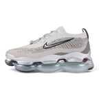 Air Max Scorpion Flyknit Gaiter Light Bone Metallic Silver - Full Lateral Profile View on Grey Background Showing Heathered Light Bone Warm Grey Speckle Flyknit Upper Light Bone Perforated Suede Overlay Black Filled Swoosh Embroidery Silver Metallic Rope Lace Powder Blue Lace Garage Smoky Mauve Terry Gaiter at Heel Collar and Large-Volume Metallic Silver AM Scorpion Air Unit