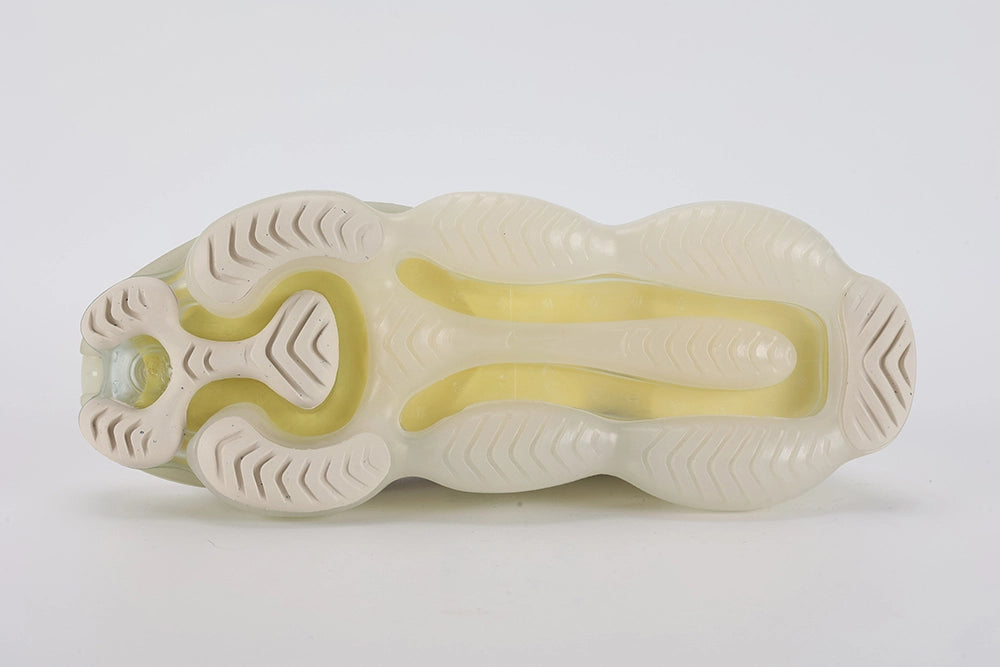 Air Max Scorpion Flyknit Lemon Wash Light Orewood Brown Lemon Chiffon - Heel Pull Tab Close Up on White Background Showing Lemon Chiffon Wide Heel Pull Tab with Black Dot-Grid Texture on Both Lateral and Medial Sides Boucle Flyknit Heel Counter and Frosted Ice AM Scorpion Air Unit at Heel with Lemon Chiffon and Volt Air Chambers Visible