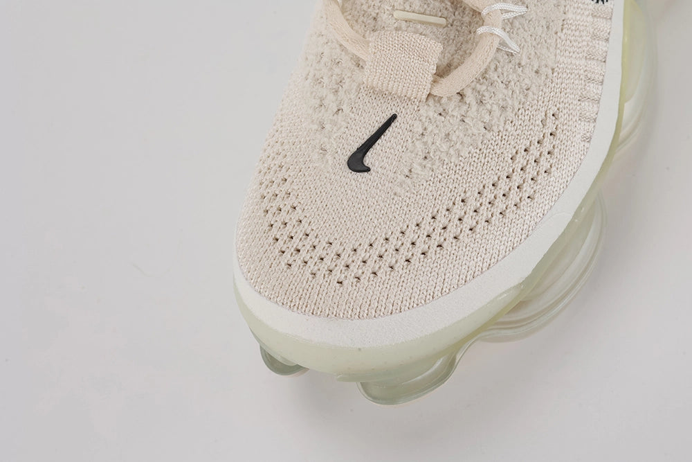 Air Max Scorpion Flyknit Lemon Wash Light Orewood Brown Lemon Chiffon - Rear View of Both Shoes on White Background Showing Lemon Chiffon Wide Heel Pull Tabs with Black Dot-Grid Texture on Both Sides Lemon Chiffon Collar Lining Boucle Flyknit Heel Counter and Frosted Ice AM Scorpion Air Unit with Lemon Chiffon and Volt Air Chambers at Heel