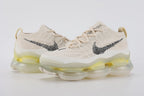 Air Max Scorpion Flyknit Lemon Wash Light Orewood Brown Lemon Chiffon - Full Outsole View on White Background Showing Frosted White Semi-Transparent AM Scorpion Air Base Lemon Chiffon Central Air Chamber Bases Volt Bright Yellow Air Chamber Bases at Heel Light Grey Forefoot Traction Zone and Cream Off-White Chevron Traction Texture