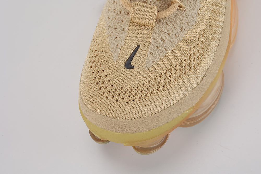 Air Max Scorpion Flyknit Sesame Dark Driftwood Total Orange - Rear View of Both Shoes on White Background Showing Sesame Wide Rubber Heel Pull Tabs with Dark Driftwood Dot-Grid Texture Sesame Collar Lining Tan Kraft Paper Hang Tags and Lemon Chiffon to Total Orange Gradient AM Scorpion Air Unit at Heel with Orange Chambers Visible