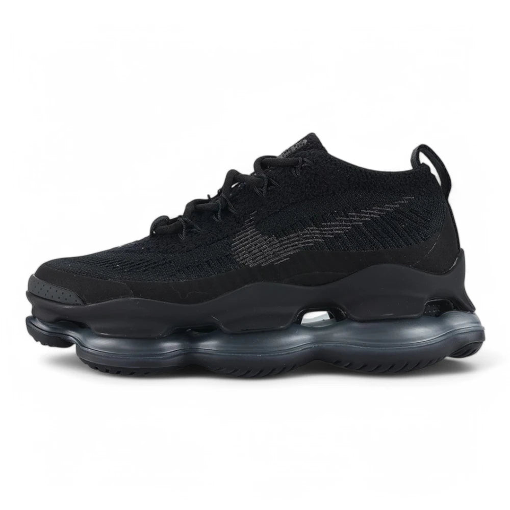 Air Max Scorpion Flyknit Triple Black Anthracite - Full Lateral Profile View on Grey Background Showing Four-Texture Black Flyknit AM Scorpion Upper Black Iridescent Flyknit on Lateral Midfoot Upper Zone Black Perforated Suede Overlay at Lower Zone Anthracite Mini Swoosh on Toe Box Black Rope Laces and Black to Dark Smoke Grey AM Scorpion Air Unit