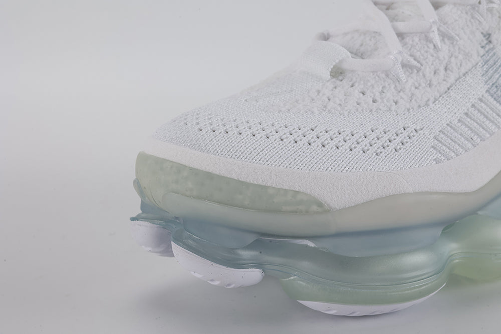 Air Max Scorpion Flyknit White Football Grey Ice Blue - Toe Box Top Down View on Grey Background Showing White Fine-Knit Flyknit with Grey Speckle Dots White Tonal Mini Swoosh White Flat Laces White Rectangular Lace Keeper with Grey Dot-Grid Texture and White Iridescent Flyknit on Lateral Midfoot
