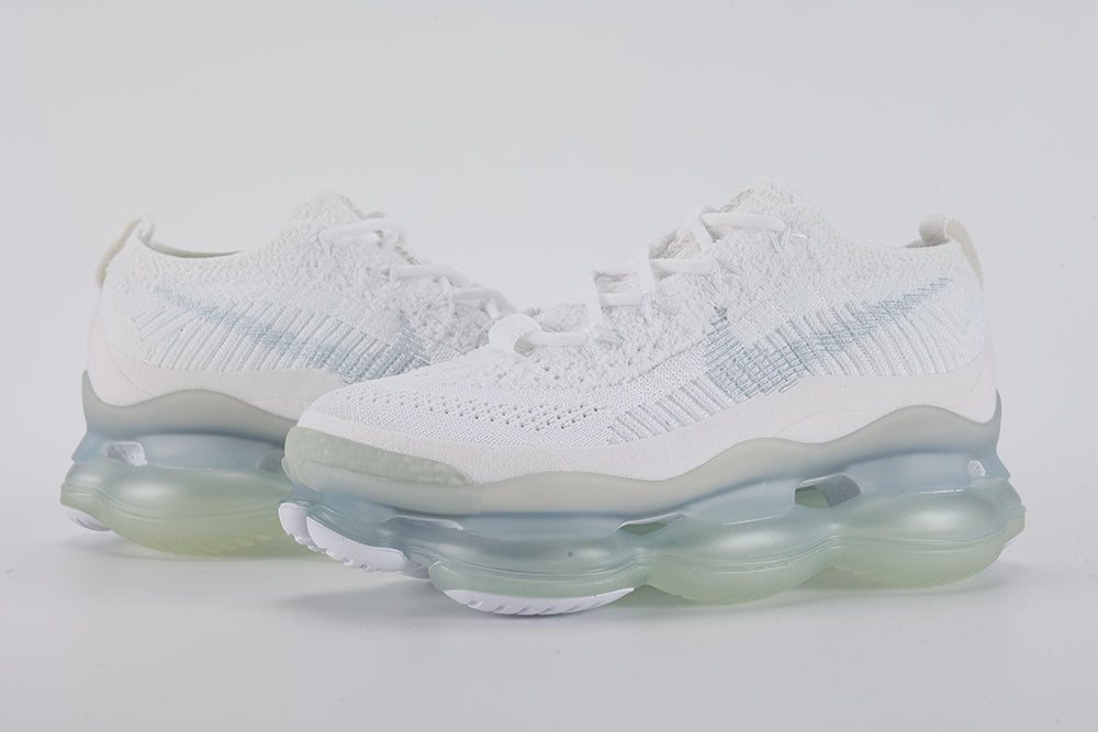 Air Max Scorpion Flyknit White Football Grey Ice Blue - Full Outsole View on Grey Background Showing Frosted White Semi-Transparent AM Scorpion Air Base Ice Blue Central Air Chamber Bases Football Grey Forefoot Traction Zone and White Rubber Chevron Traction Pods at Forefoot and Heel
