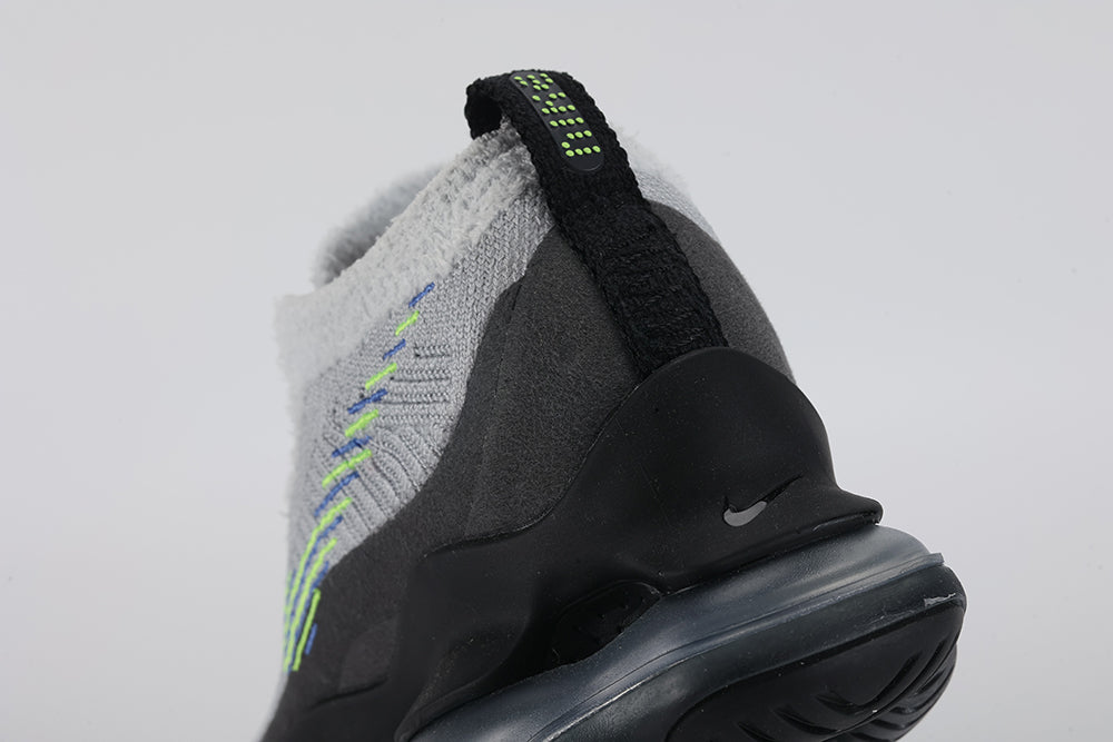 Air Max Scorpion Flyknit Wolf Grey Volt Racer Blue Black - Collar and Lace Area Close Up on Grey Background Showing White Terry Loop-Pile Flyknit Collar Wolf Grey Fine-Knit Flyknit with Volt and Racer Blue Knit Stripes White Flat Laces Racer Blue Dot-Matrix on Collar Interior and Black AM Scorpion Air Unit