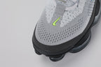 Air Max Scorpion Flyknit Wolf Grey Volt Racer Blue Black - Rear View of Both Shoes on Grey Background Showing Black Wide Flyknit Heel Pull Tabs with Volt Dot-Matrix Pattern Wolf Grey Flyknit Heel Counter with Volt and Racer Blue Knit Stripes Black Collar Lining and Black to Dark Grey AM Scorpion Air Unit at Heel