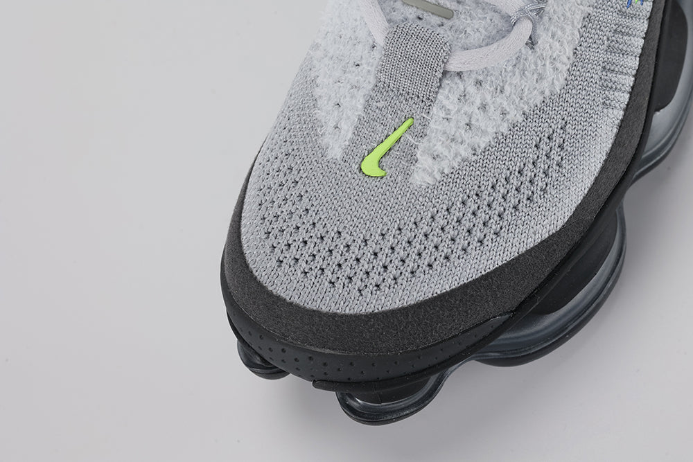 Air Max Scorpion Flyknit Wolf Grey Volt Racer Blue Black - Rear View of Both Shoes on Grey Background Showing Black Wide Flyknit Heel Pull Tabs with Volt Dot-Matrix Pattern Wolf Grey Flyknit Heel Counter with Volt and Racer Blue Knit Stripes Black Collar Lining and Black to Dark Grey AM Scorpion Air Unit at Heel