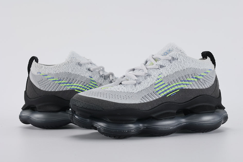 Air Max Scorpion Flyknit Wolf Grey Volt Racer Blue Black - Full Outsole View on Grey Background Showing Full-Coverage Black AM Scorpion Air Base Dark Grey Central Air Chamber Bases and Black Rubber Chevron Traction