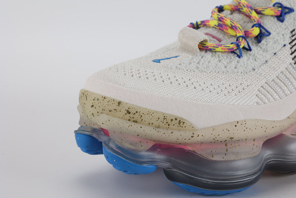 Air Max Scorpion Hiking - Tongue and Lace Area Top Down View on White Background Showing Sail Boucle Flyknit Tongue Tan Leather Rectangular Tongue Badge Blue Star-Form Lace Locks Multicolour Paracord Lace and Dark Grey Ankle Collar Lining