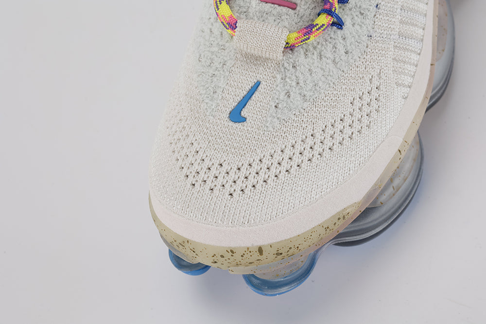 Air Max Scorpion Hiking - Rear View of Both Shoes on White Background Showing Wide Tan Leather Heel Pull Tabs with H-Form Stitch Structure on Both Sides Sail Boucle Flyknit Heel Counter Dark Grey Ankle Collar Lining and Pink Air Chambers Visible Through Frosted Grey AM Scorpion Midsole with Blue Traction Pods