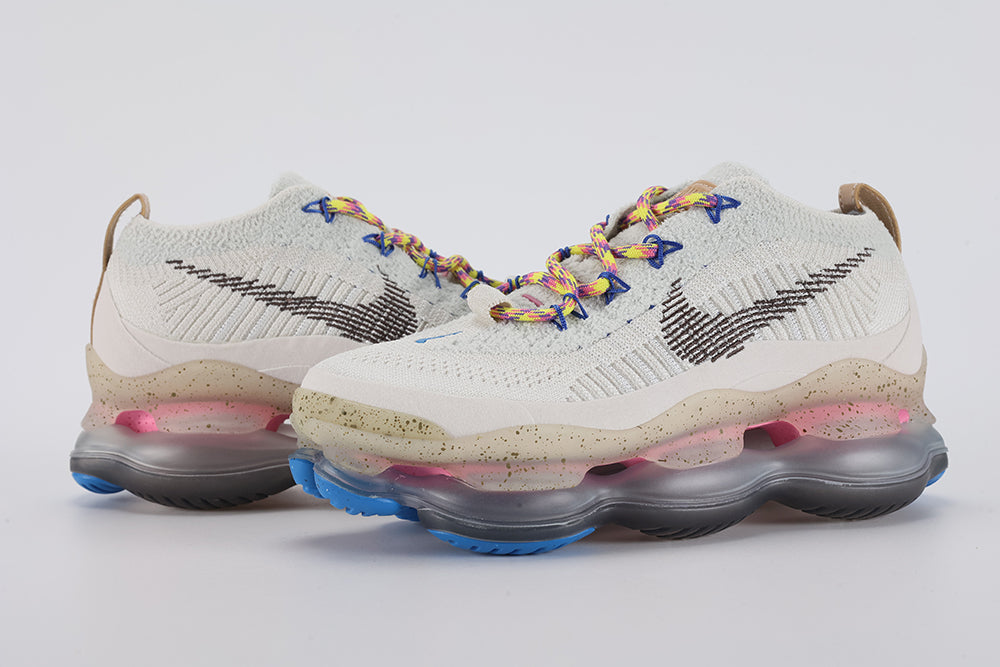 Air Max Scorpion Hiking - Full Outsole View on White Background Showing Dark Brown Olive Semi-Transparent Air Chamber Bases with Chevron Traction Texture Pink Air Chambers at Midfoot and Heel and Blue Rubber Traction Pods at Forefoot and Heel Corners