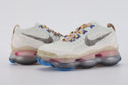 Air Max Scorpion Hiking - Full Outsole View on White Background Showing Dark Brown Olive Semi-Transparent Air Chamber Bases with Chevron Traction Texture Pink Air Chambers at Midfoot and Heel and Blue Rubber Traction Pods at Forefoot and Heel Corners