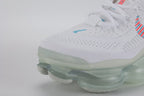 Air Max Scorpion Lagoon Pulse - Tongue and Lace Lock Close Up on White Background Showing Teal Lagoon Pulse Mini Swoosh Embroidery on White Flyknit Tongue Hot Punch Coral-Red Oval Rubber Lace Locks with Teal Dot-Grid Texture and White Flat Laces