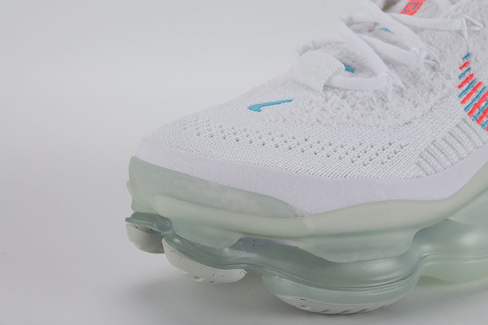Air Max Scorpion Lagoon Pulse - Tongue and Lace Lock Close Up on White Background Showing Teal Lagoon Pulse Mini Swoosh Embroidery on White Flyknit Tongue Hot Punch Coral-Red Oval Rubber Lace Locks with Teal Dot-Grid Texture and White Flat Laces