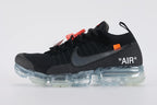 Air VaporMax co-branded Part 2 Black White Orange - Toe Box Close Up on White Background Showing Black Fine-Knit Flyknit Toe Box Dark Grey Flyknit Zone at Lower Lateral Midfoot Orange Industrial Zip Tie and Frosted Ice VaporMax Cylindrical Air Chamber Array at Forefoot
